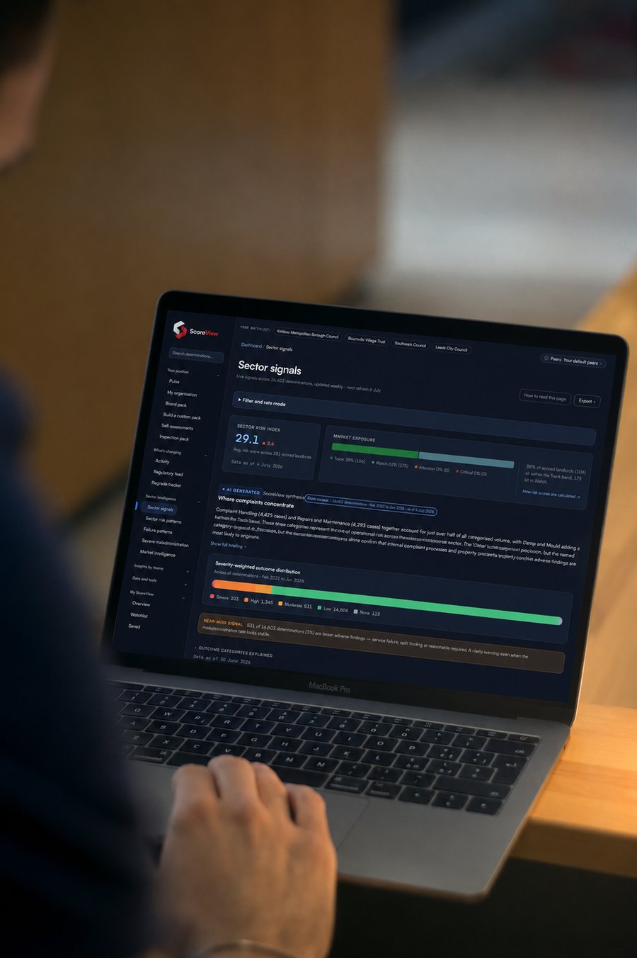 A housing professional reviewing ScoreView Sector signals on a laptop - sector risk index, market exposure and AI synthesis